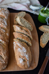Fresh French home made Baguette Bread with wild garlic on dark background