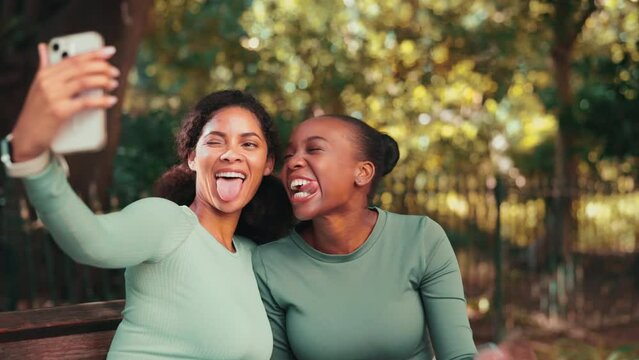 Fitness women, park selfie and together with funny face, kiss or relax on bench with social media at training. Woman, runner team and photography for profile picture, post or laugh in nature together