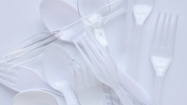 Disposable transparent plastic spoon and fork. Plastic spoon and fork on white background. concept environmental problems.