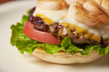 Cheese, beef and shrimp burgers on a plate