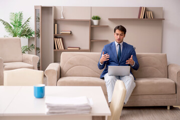 Young male employee working from home during pandemic