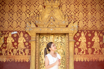 Fototapeta premium Portrait of An Asian Woman at Wat Sene Souk Haram ,Luang Prabang, LAOS 