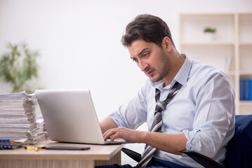 Fototapeta premium Young male employee and too much work in the office