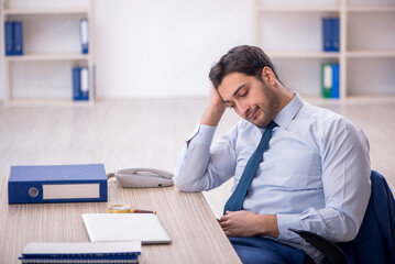 Young male employee working in the office