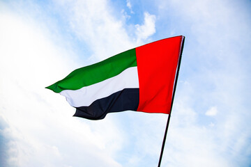 Waving fabric texture of the flag with color of United Arab Emirates, UAE real texture flag