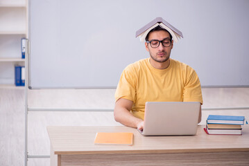 Young male student in telestudying concept