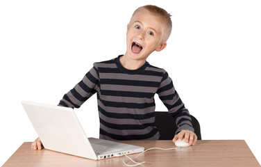 Young boy playing on a laptop
