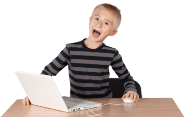 Young boy playing on a laptop