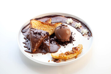 Chocolate french toast with a scoop of chocolate gelato ice cream on the side and banana sliced.