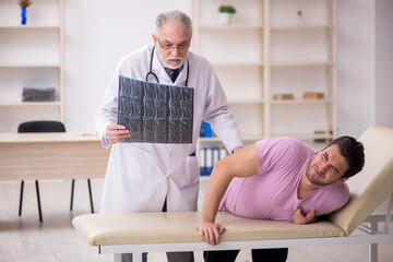 Young male patient visiting old male doctor radiologist