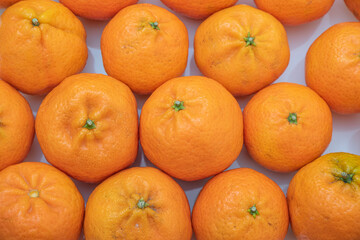 tangerine on a white background. How to choose, store and how much you can eat so as not to harm...