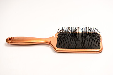 A red hairbrush isolated on a white background. Hair tools.