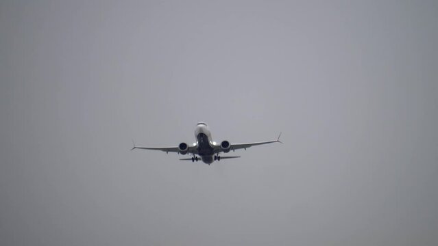 Boeing 737 Max Airplane Taking Off, Front View, Overcast Day.