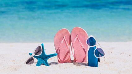 Pink Flip flop in  tropical summer a holiday and accessories on the beach background