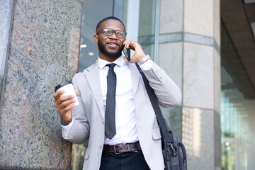 Black Businessman Having A Call During The Coffee Break. Modern Office Building

