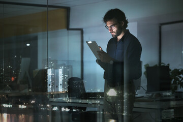 Night, news or businessman with tablet in office to search digital technology, data analytics or global media. City view, entrepreneur or focused person typing on iot dashboard or networking online