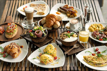 Fototapeta na wymiar many mixed western breakfast food items on cafe table