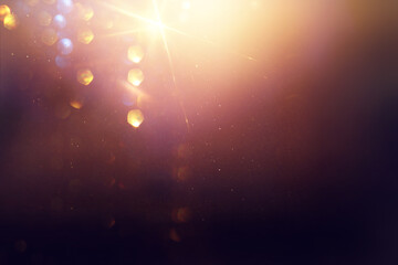 background of abstract glitter lights. gold and black. de focused