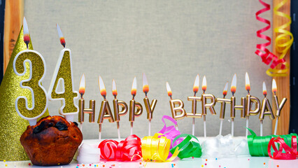 Happy birthday background with golden candles and decorations with candles burning number  34....