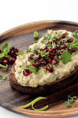 Baba ghanoush eggplant dip and pomegranate seeds on toast