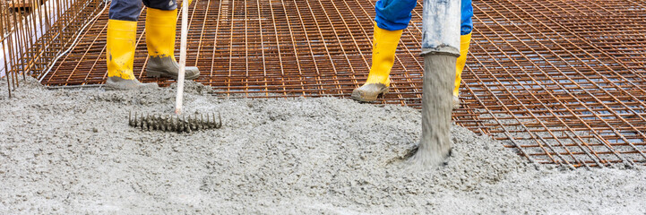 workers concreting the foundation of a house