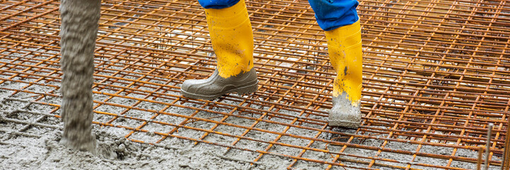 workers concreting the foundation of a house