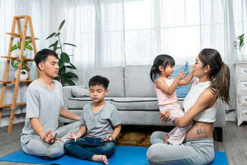  Asian family of parents, sons and daughters are happily relaxing in the middle of house, Beautiful teenage mother who is pregnant with a big belly near giving birth plays with her daughter.