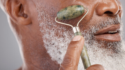 Face roller, closeup and senior man with skincare, stone and dermatology product for skin glow....