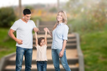Fototapeta premium Happy young family walking at park