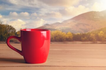 Obraz premium Tasty hot tea in cup in the sunrise background.