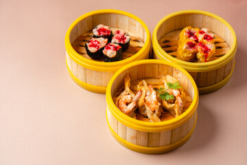 Assorted Chinese Dimsum in bamboo basket. Dimsum is a large range of small dishes that Cantonese people traditionally enjoy in restaurants for breakfast and lunch.