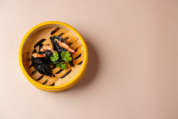 Assorted Chinese Dimsum in bamboo basket. Dimsum is a large range of small dishes that Cantonese...
