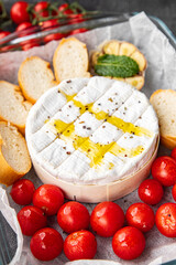 cheese baked tartiflette tomato, garlic and herbs meal food snack on the table copy space food background rustic top view