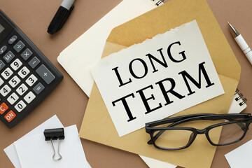 long term claims calculator glasses top view. text on paper on an envelope