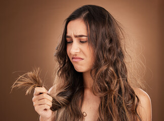 Beauty, crisis and sad woman in studio with hair loss, dry and damage against brown background....