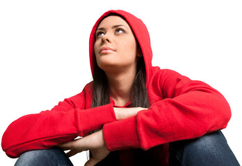 Portrait of beautiful young casual girl sitting on a white background