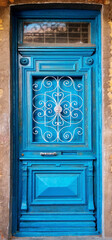 Old wooden painted blue door with silver metal decor in Old Town of Tbilisi, Georgia.