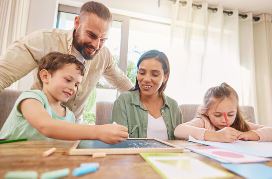 Family, education and homework with a boy writing on a chalkboard while his parents supervise his learning. Kids, school or study with children, a mother and father at home for growth or development