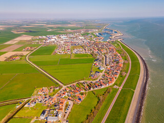 High angle Drone Point of View on the Village of Oudeschild, located on the island of Texel, The Netherlands. The Wadden Sea can be seen on the right.