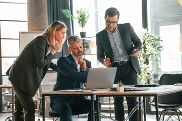 Men and woman indoors. Group of business people are working in the modern office