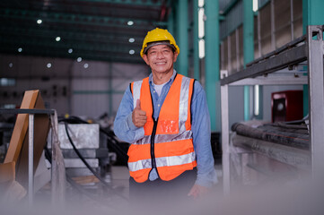 senior engineer working inside the building of a manufacturing plant. industrial plant