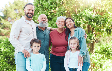 Family is outdoor, smile in portrait with generations, happiness with grandparents, parents and kids in garden. Happy people together, summer holiday and bonding with love, care and support in nature