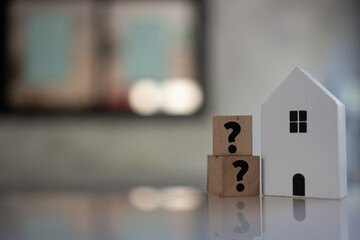 Model of house and question marks. Question for home concept