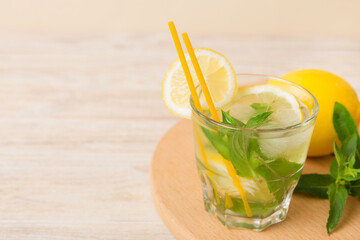 Mojito cocktail. Refreshing mojito cocktail with lime, lemon and mint in a tall glass with a stick