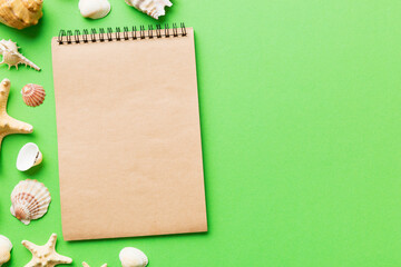 Blank writing book with summer beach accessories on background, copy space. Flat lay with copy space