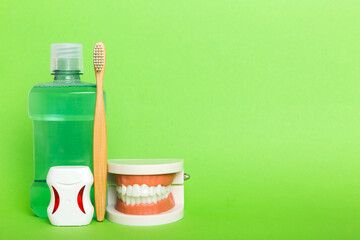 Mouthwash and other oral hygiene products on colored table top view with copy space. Flat lay. Dental hygiene. Oral care kit. Dentist concept