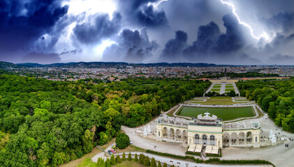 Schonbrunn Palace aerial panoramic view during a storm in Vienna, Austria. Schloss Schoenbrunn is an imperial summer residence - obrazy, fototapety, plakaty