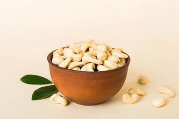 cashew nuts in wooden bowl on table background. top view. Space for text Healthy food