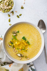 Healthy lunches, cream soup of yellow and orange lentils with fried onions and spinach leaves and curry, useful legums, top view