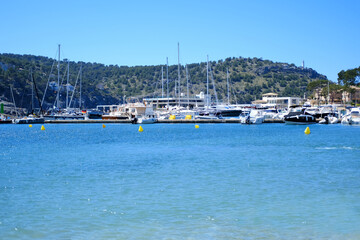 Fototapeta na wymiar beautiful blue sea, yachts, boats, sea pier, Port de Soller city, mallorca harbor, concept water sports in mediterranean, lack of drinking water, climate change, global warming, vacation and travel